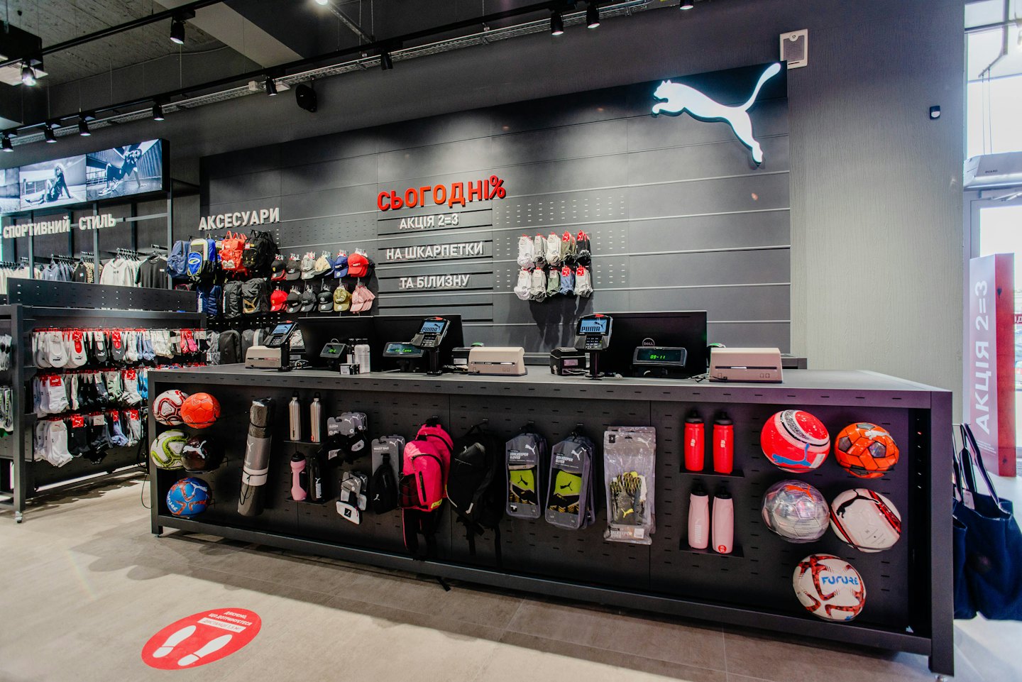 Sports retail store interior with checkout counter and merchandise.