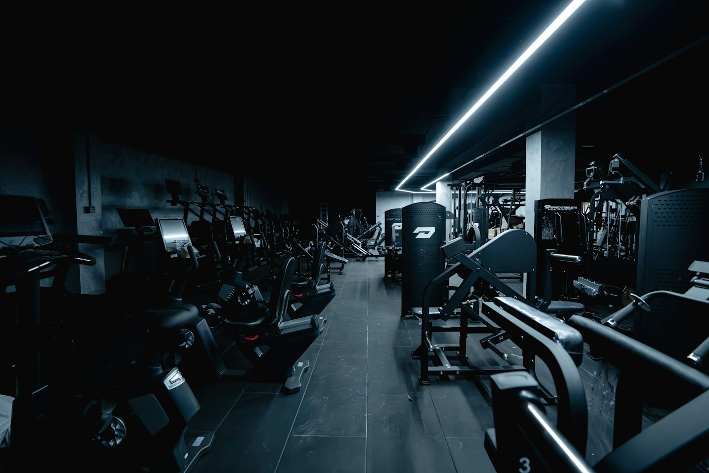 Modern gym with exercise bikes and punching bag.