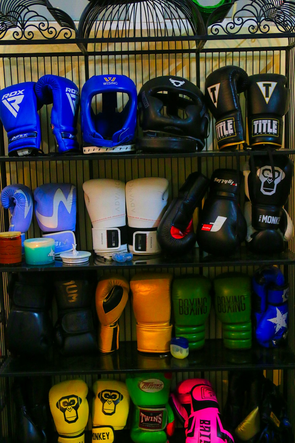 Boxing gloves and combat equipment displayed on store shelves.
